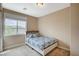 This cozy bedroom has natural light, plush carpet, and neutral decor at 549 Via Balizan Ave, Las Vegas, NV 89123