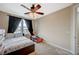 Well-lit bedroom with ceiling fan, complemented by a full-sized bed and secondary bed at 549 Via Balizan Ave, Las Vegas, NV 89123