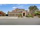 Stunning two-story home features a three-car garage, arched entryway, and well-maintained landscaping at 549 Via Balizan Ave, Las Vegas, NV 89123