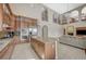 Gourmet kitchen with custom cabinets, granite countertops, and a stainless steel fridge/freezer at 549 Via Balizan Ave, Las Vegas, NV 89123