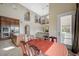 View from the dining area to the kitchen and living room with soaring ceilings and bright natural light at 549 Via Balizan Ave, Las Vegas, NV 89123