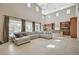 Bright living room boasts soaring ceilings, tile flooring, and an oversized sectional couch at 549 Via Balizan Ave, Las Vegas, NV 89123