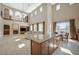 Open floorplan with fireplace, kitchen island, soaring ceilings, and custom ironwork balconies at 549 Via Balizan Ave, Las Vegas, NV 89123