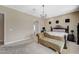 Main bedroom with a large window, carpeted floors, and a comfortable chaise lounge at 549 Via Balizan Ave, Las Vegas, NV 89123