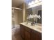Bathroom featuring double sinks, a shower with glass doors, and neutral decor at 5518 Ovando Way, Las Vegas, NV 89122