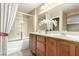Bright bathroom features a double sink vanity, tub, and a shower at 5518 Ovando Way, Las Vegas, NV 89122