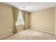 Bright bedroom features neutral walls, plush carpeting, and a window with decorative curtains at 5518 Ovando Way, Las Vegas, NV 89122