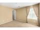 Inviting bedroom featuring neutral walls, plush carpeting, and a window with decorative curtains at 5518 Ovando Way, Las Vegas, NV 89122