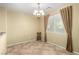 Cozy dining room with tile floor, single chair, chandelier, and window at 5518 Ovando Way, Las Vegas, NV 89122