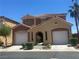 Charming two-story home with a well-maintained front yard, two-car garage, and desert landscaping at 5518 Ovando Way, Las Vegas, NV 89122