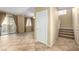 Entrance foyer with tile floors, stairs, sliding glass door, and neutral walls at 5518 Ovando Way, Las Vegas, NV 89122