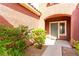 Inviting front entrance with landscaped bushes and a walkway leading to the front door at 5518 Ovando Way, Las Vegas, NV 89122