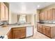 Kitchen featuring wood cabinets, light countertops, and a breakfast bar at 5518 Ovando Way, Las Vegas, NV 89122