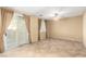 Spacious living room with a ceiling fan, tile floors, and sliding glass doors to the backyard at 5518 Ovando Way, Las Vegas, NV 89122