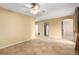 Large living room featuring tile flooring, ceiling fan, with archways leading into the kitchen at 5518 Ovando Way, Las Vegas, NV 89122