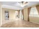 Open-concept living room with tile floors, a ceiling fan, and views of the kitchen and backyard at 5518 Ovando Way, Las Vegas, NV 89122