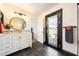 Modern bathroom boasts a white vanity, a large mirror, and access to an outdoor balcony at 5570 N Nopah Vista Ave, Pahrump, NV 89060