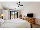 Tranquil bedroom with hardwood floors, a ceiling fan, and backyard access, promoting comfort and style at 5570 N Nopah Vista Ave, Pahrump, NV 89060