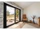 Bedroom showing backyard access and view with hardwood floors, stylish decor, and a serene ambiance at 5570 N Nopah Vista Ave, Pahrump, NV 89060