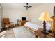 Cozy bedroom with hardwood floors, ceiling fan, and a warm and inviting ambiance, perfect for relaxation at 5570 N Nopah Vista Ave, Pahrump, NV 89060