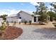 Charming home with desert landscaping, a white tile roof, and a walkway to the front door at 5570 N Nopah Vista Ave, Pahrump, NV 89060