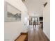 Inviting hallway with wooden floors leading to a dining area with a fireplace and outdoor view at 5570 N Nopah Vista Ave, Pahrump, NV 89060