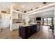 Open-concept kitchen featuring an island, granite counters, stainless appliances and bright natural light at 5570 N Nopah Vista Ave, Pahrump, NV 89060