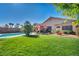 Expansive backyard featuring a well-manicured lawn, pool, and an inviting outdoor seating area at 5578 River Highlands Pl, Las Vegas, NV 89122