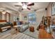 Cozy bedroom featuring wood floors, ceiling fan and comfortable seating area at 5578 River Highlands Pl, Las Vegas, NV 89122