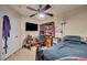 Bedroom featuring a ceiling fan, a desk, and a bed with dark bedding at 5578 River Highlands Pl, Las Vegas, NV 89122