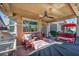 Relaxing covered patio featuring comfortable seating, ceiling fan, and outdoor grill, perfect for entertaining or enjoying the outdoors at 5578 River Highlands Pl, Las Vegas, NV 89122