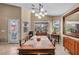 Bright dining room with a wooden table set, tile floors, and a view to the outside at 5578 River Highlands Pl, Las Vegas, NV 89122