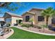 Well-maintained home with manicured landscaping featuring green grass and desert elements for a charming curb appeal at 5578 River Highlands Pl, Las Vegas, NV 89122