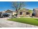 Attractive single-story house showcasing tidy landscaping with stone, artificial turf, and a healthy shade tree at 5578 River Highlands Pl, Las Vegas, NV 89122