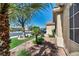 Lush landscaping with rocks, lights, and mature plantings beautifully frames this home, creating an inviting outdoor space at 5578 River Highlands Pl, Las Vegas, NV 89122