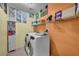 Laundry room equipped with modern washer and dryer units and organized shelving at 5578 River Highlands Pl, Las Vegas, NV 89122