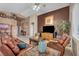 Cozy living room with leather seating, a ceiling fan, and neutral decor at 5578 River Highlands Pl, Las Vegas, NV 89122