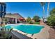 Beautiful backyard pool surrounded by desert landscaping, patio area, and well-maintained yard at 5578 River Highlands Pl, Las Vegas, NV 89122