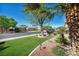 This street view shows mature trees and well-kept lawns of neighboring homes for an established neighborhood feel at 5578 River Highlands Pl, Las Vegas, NV 89122