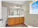Well-lit bathroom featuring a single vanity, framed mirror, and tile floors at 5783 Sol Vista Ave, Las Vegas, NV 89122