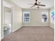 Bedroom with neutral walls, carpet, two windows and an attached bathroom at 5783 Sol Vista Ave, Las Vegas, NV 89122