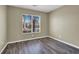 Bedroom featuring gray wood floors and large windows at 5783 Sol Vista Ave, Las Vegas, NV 89122
