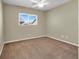 Neutral bedroom with a window letting in natural light and plush carpeting at 5783 Sol Vista Ave, Las Vegas, NV 89122