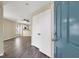 The entryway has gray wood floors and leads to an open living room and kitchen at 5783 Sol Vista Ave, Las Vegas, NV 89122
