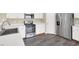 Well-lit kitchen features stainless steel appliances, white countertops and cabinets, and wood-look flooring at 5783 Sol Vista Ave, Las Vegas, NV 89122