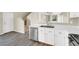 The kitchen offers white cabinets, stainless steel appliances, and a view into the living area at 5783 Sol Vista Ave, Las Vegas, NV 89122