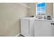 The laundry room has a washer and dryer, plus shelving at 5783 Sol Vista Ave, Las Vegas, NV 89122
