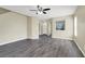 Spacious living room features modern ceiling fan and neutral paint, and grey wood-look flooring at 5783 Sol Vista Ave, Las Vegas, NV 89122