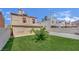 Fenced backyard with green lawn and partial desert landscaping at 5845 Killala Ct, Las Vegas, NV 89110