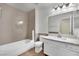 Updated bathroom featuring a tub, modern fixtures, and white vanity with countertop at 5845 Killala Ct, Las Vegas, NV 89110